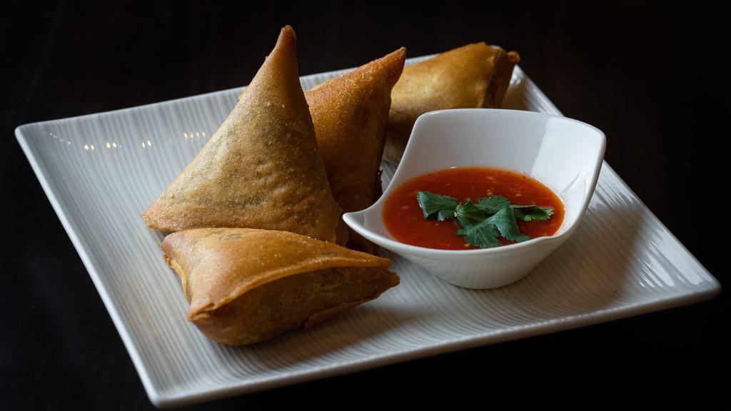 Samosas · Vegan. Hand-made wheat-flour wraps fried and filled with potatoes, onions and spices. Served with our special house sauce.