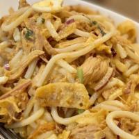 Nan Gyi Dok · Rice noodles with coconut chicken curry, yellow bean powder, cilantro, red onions, fried oni...