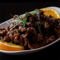 Sesame Beef · Strips of beef lightly fried in a sweet and tangy sauce, sliced and topped with sesame seeds.
