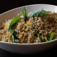 Pine Nut Fried Rice · Gluten-free. Brown rice with pine nuts, pea leaves, egg and garlic.