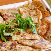Bolani · Traditional Afghan flat bread, filled with flavored potato, scallion, cilantro, light spice ...