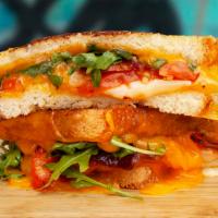 BLT Grilled Cheese · Melted cheddar, crisp bacon, lettuce, tomato, and mayo between two slices of buttery grilled...