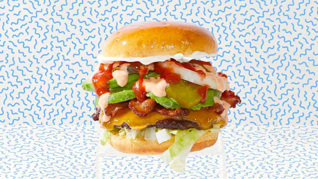 Smash Bacon Avocado Burger · Smash burger with beef bacon, avocado, cheddar cheese, lettuce, tomatoes, onion, pickles, and mayo.