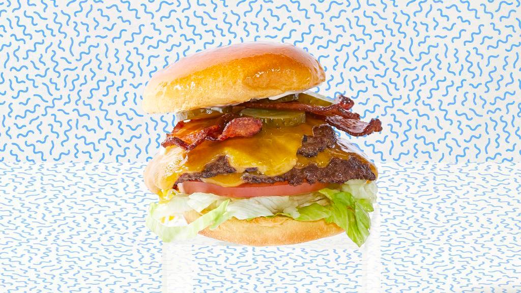 Double Bacon Smash Cheeseburger · Two smash burger patties with bacon, cheddar cheese, lettuce, tomatoes, onion, pickles, and mayo.