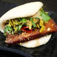 Pork Belly Bao · A Taiwanese classic. Slow-cooked pork belly with mustard greens, peanuts, and cilantro.