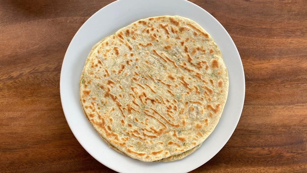 Coconut Titiyas (2) · Traditional flatbread made with green onion and coconut milk. A delicious addition to any dish.