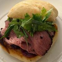 Smoked Tri-Tip Steak Sandwich · coffee-black pepper rub, red wine onion jam, aïoli, herbs, melted gouda, ciabatta