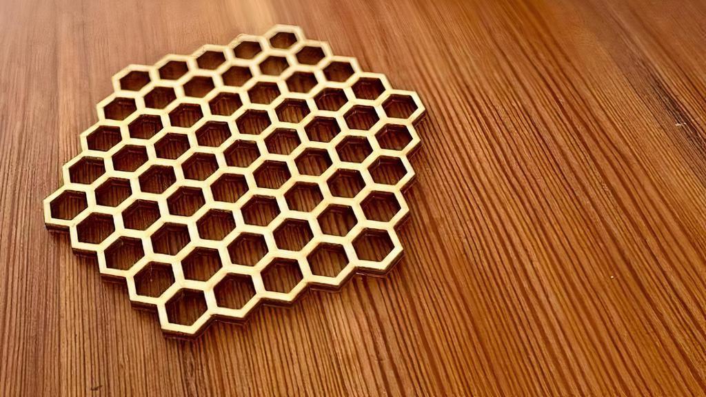 Laser Cut Honeycomb Wood Coasters · These coasters are just under 4” in diameter and 1/8” thick. They’re made from Baltic birch plywood which is laser cut into the honeycomb pattern. They’re unfinished and quite rugged despite their lightweight design. Made from Baltic Birch plywood