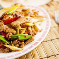 Mongolian Beef 蒙古牛肉 · Sliced beef sauteed with green & yellow onions, shredded carrots, and garlic.  Spicy, garlic...