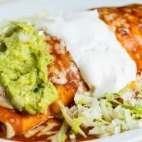 Famoso Burrito · Big burrito topped with enchilada sauce & cheese. Served with rice, beans, & cheese inside. ...