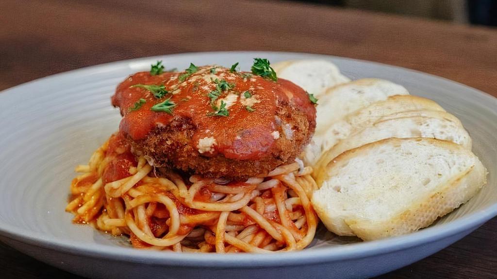 Chicken Parmesan with Spaghetti · Crispy Golden Chicken covered in Melted Cheese and Marinara Sauce on a bed of Spaghetti Noodles.
