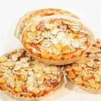 Almond Tart · Almond slices over sweet buttery crust, raspberry jam, and frangipane.