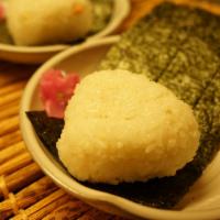 Salmon Flake Onigiri · Rice ball and salmon flake inside.