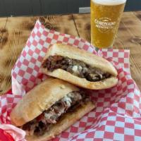 Cheesesteak · Beef, peppers onions choice of cheese: American or provolone, hot and or sweet peppers.