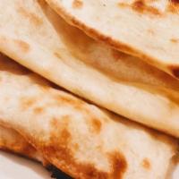Naan · Unleavened bread baked in the tandoor.