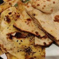 Bread Basket · Assortment of one roti, one garlic and basil naan, and one onion kulcha.