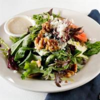 Baby Field Salad · Mixed greens with feta cheese & candied walnuts in a honey mustard herb dressing.