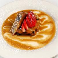 Bread Pudding · Baked with bourbon, cinnamon, brown sugar and raisins served with creme anglaise and caramel.