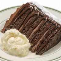 Your Favorite Chocolate Cake · A huge slice of layered chocolate cake served with a scoop of vanilla ice cream, drizzled wi...