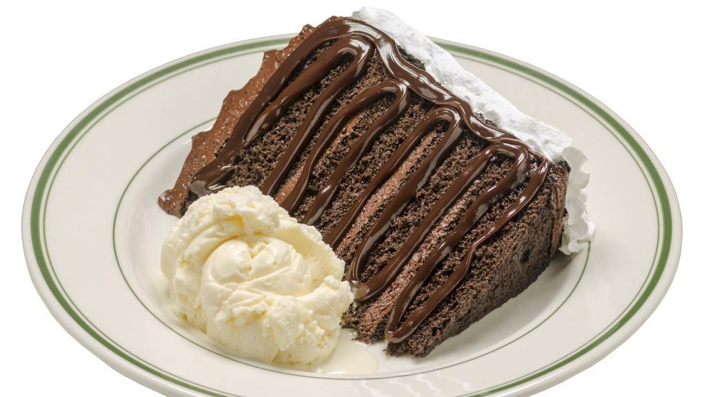 Your Favorite Chocolate Cake · A huge slice of layered chocolate cake served with a scoop of vanilla ice cream, drizzled with chocolate syrup and topped with whipped cream.