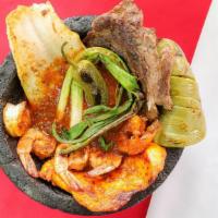 molcajete pancho villa · steak ,chicken, fish, shrimp  nopal  green onions  jalapeno with tomatillo red sauce . - ser...