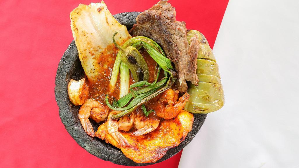 molcajete pancho villa · steak ,chicken, fish, shrimp  nopal  green onions  jalapeno with tomatillo red sauce . - served with rice beans lettuce sour cream and pico de gallo .