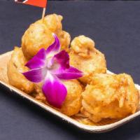 Accra Saltfish Fritters · Deep-fried fritter served with spicy tropical dip.