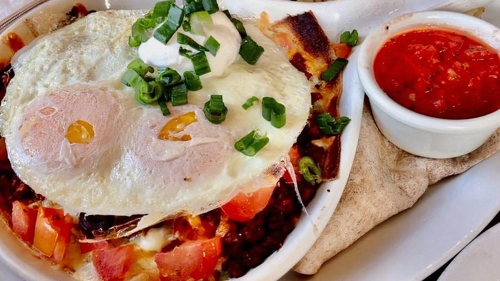 GF- Huevos Rancheros · A -corn tortilla topped with chorizo, refried and black beans, avocado, black olives, onions, tomatoes, cheddar-jack cheese, salsa, sour cream, green chilies, and scallions with 2 over-easy eggs. Served with potatoes.