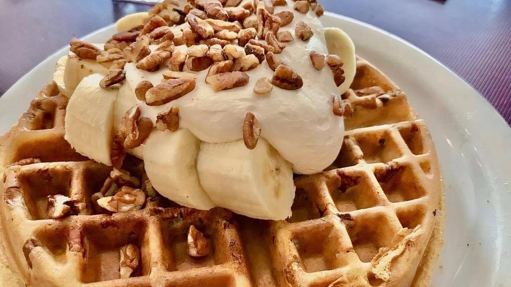 GF - Banana Pecan Waffle · Filled with roasted pecans, topped with sliced bananas and fresh whipped cream.