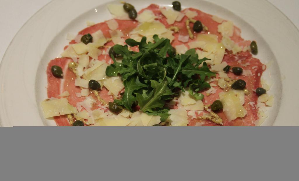 Carpacio Di Manzo · Thin sliced raw beef with capers, cheese, onions, mustard, Parmesan cheese.