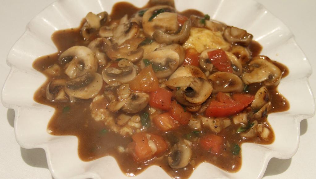 Polenta Alla Funghi · Soft polenta served with sautéed mushroom, basil, fresh tomato in a brown sauce.
