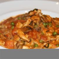 Capellini Al Pollo · Angel hair pasta with chicken, mushrooms, green peas, tomato cream sauce.