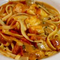 Fettuccine Alla Salmone · Flat pasta with salmon and tomato cream sauce.