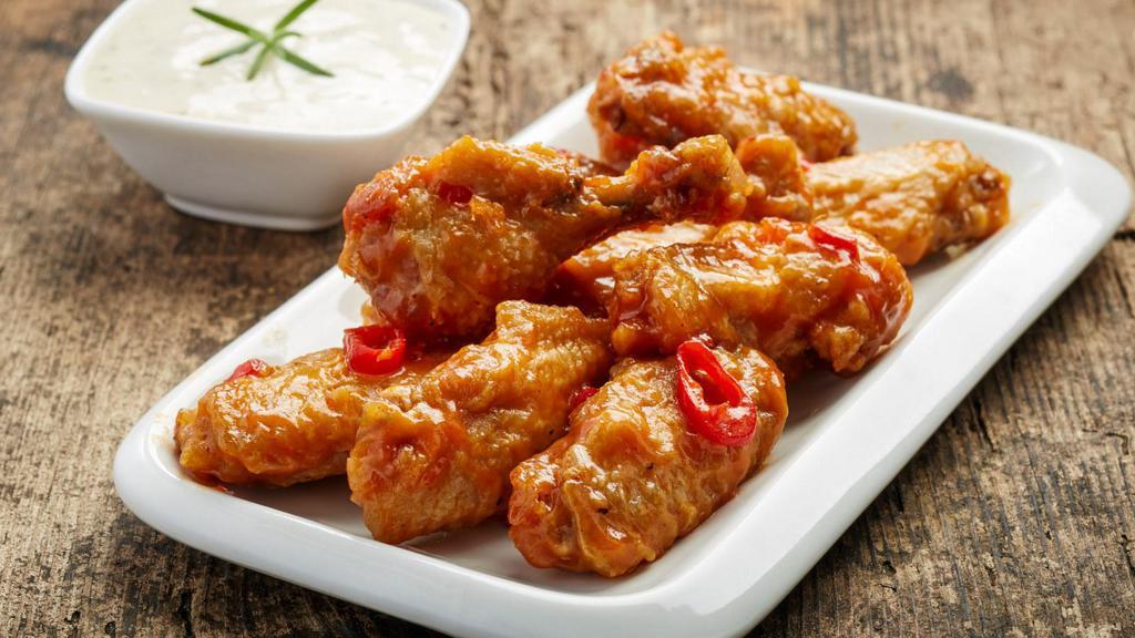 Sweet Chili Chicken Wings · Perfect combo of sweet and spicy in wing form. Served with a side of ranch dressing.