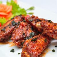 BBQ Chicken Wings · Sweet and tangy BBQ chicken wings served with a side of ranch dressing.
