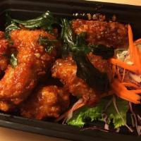 Siam Wings · Deep-fried chicken wings sautéed with sweet and spicy sauce and topped with fried basil leav...