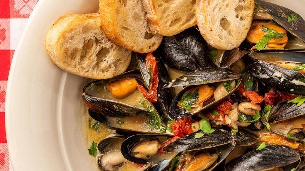 Prince Edward Island Steamed Mussels, Tuscan Style · Cannellini Beans, Sun-Dried Tomatoes, Lemon, Roasted Garlic, White Wine Sauce
