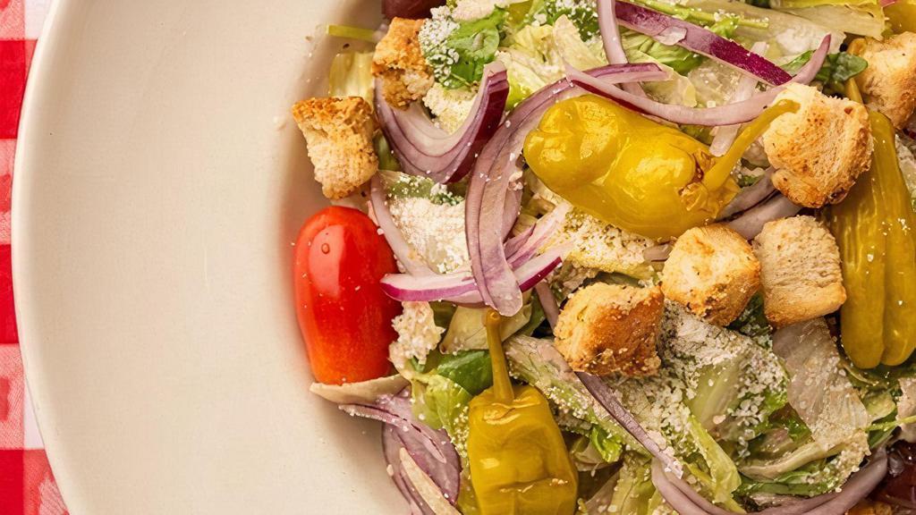 Italian Tossed Salad · Iceberg, Arugula, Kalamata Olives, Red Onions, Pepperoncini, Italian Cheese Blend, Garlic Croutons, Italian Vinaigrette