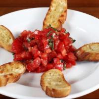 Brushchetta · Roma tomatoes, basil, garlic, olive oil, and grilled baguette.