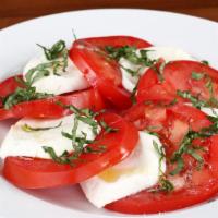 Caprese · Mozzarella, sliced tomatoes, basil, and a drizzle of olive oil.
