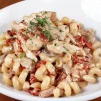 Cavatappi · Grilled chicken, chunks of applewood bacon, crimini mushrooms, sun-dried tomatoes, and a cre...