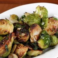 Cavolini · Roasted Brussel sprouts with sautéed red onions, and herbs.