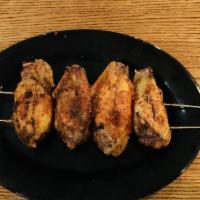  烤 鸡翅 / Chicken Wings · Cooked wing of a chicken coated in sauce or seasoning.