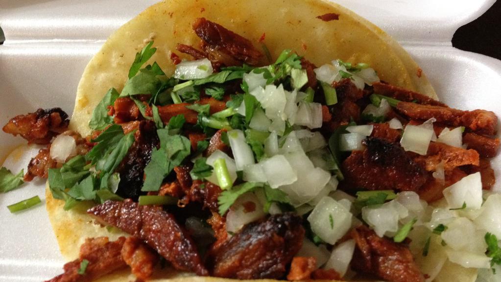 Tacos Al Pastor · corn tortilla , marinade pork meat  ,pineapple ,onions ,cilantro and sauces