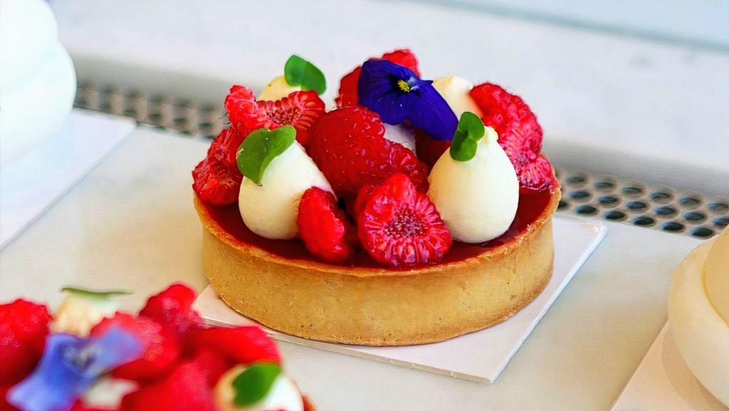 Wild Vanilla & Raspberry Tart · Sugar dough tart shell filled with a baked almond cream that brings a smooth texture, a diplomate vanilla cream (wich is a mix of pastry cream and ganache montée), fresh raspberries and a 100% fresh fruit raspberry gel.