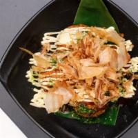 Takoyaki (4 pcs) · Octopus fritter topped with okonomi sauce and bonito flakes.