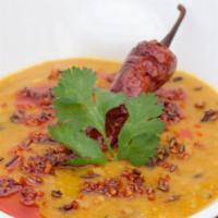 Dal Tadka Dhaba · butter tempering with cumin, onion garlic and dried red chillies over yellow lentils