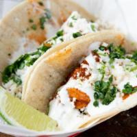 Pulled Chicken Tacos (2 Pcs.) · Gluten free. Chipotle chicken, caramelized onion, peanut mole, sour cream and queso fresco.
