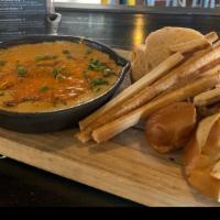 Beer Cheese Fondu · Sharp Cheddar & Gruyere cheese infused with Guinness stout served with toasted Bavarian pret...