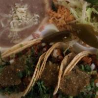 Taco Combo · Three tacos, meat, rice, beans, onion, cilantro, and salsa.